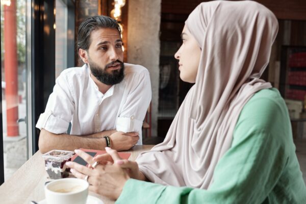 Muslim Couple In Modern Cafe